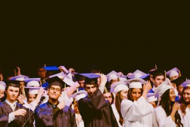 Graduating students in cap and gown - photo from academica